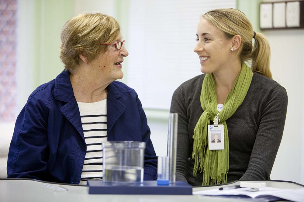 Health professional and patient sat talking